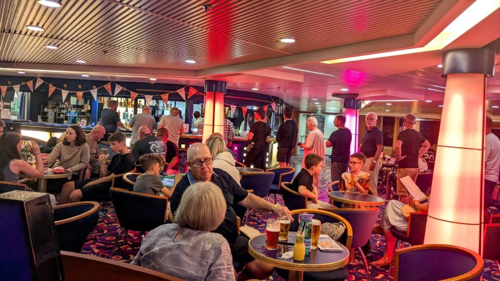 lots of people sat in a bar on a ferry