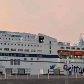 a brittany ferries ferry to france from portsmouth, with the sun rising behind it