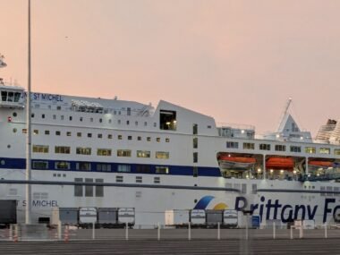 a brittany ferries ferry to france from portsmouth, with the sun rising behind it