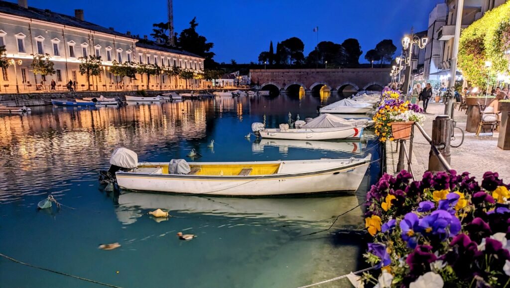 peschiera del garda by night with a boat on the water