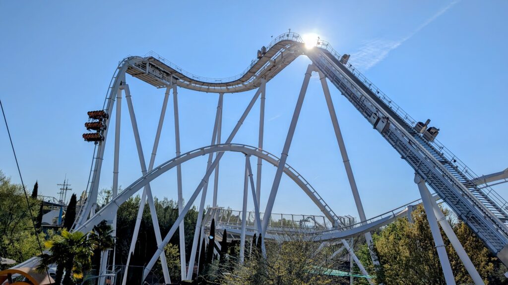 the oblivion rollercoaster at gardaland resort in italy, with a clear blue sky in the background