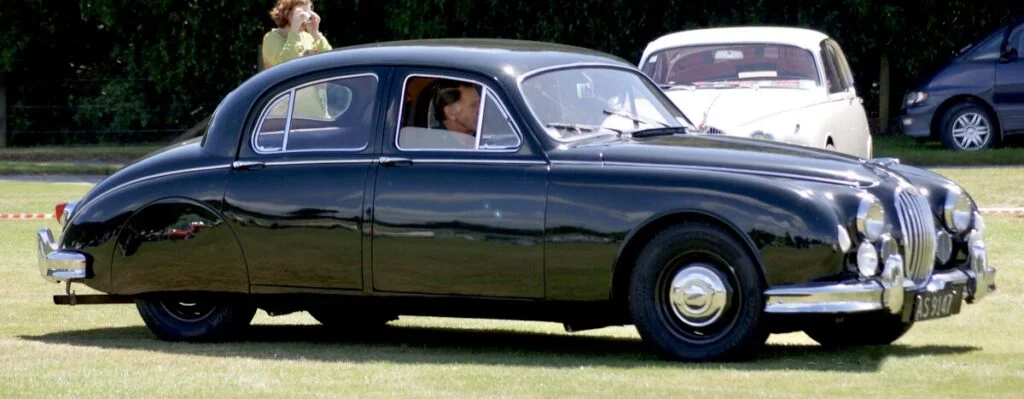 a luxury jaguar car being driven on grass renting a car in uk