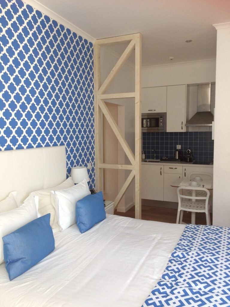 a room with blue tiled walls and a bed in dream chiado apartments
