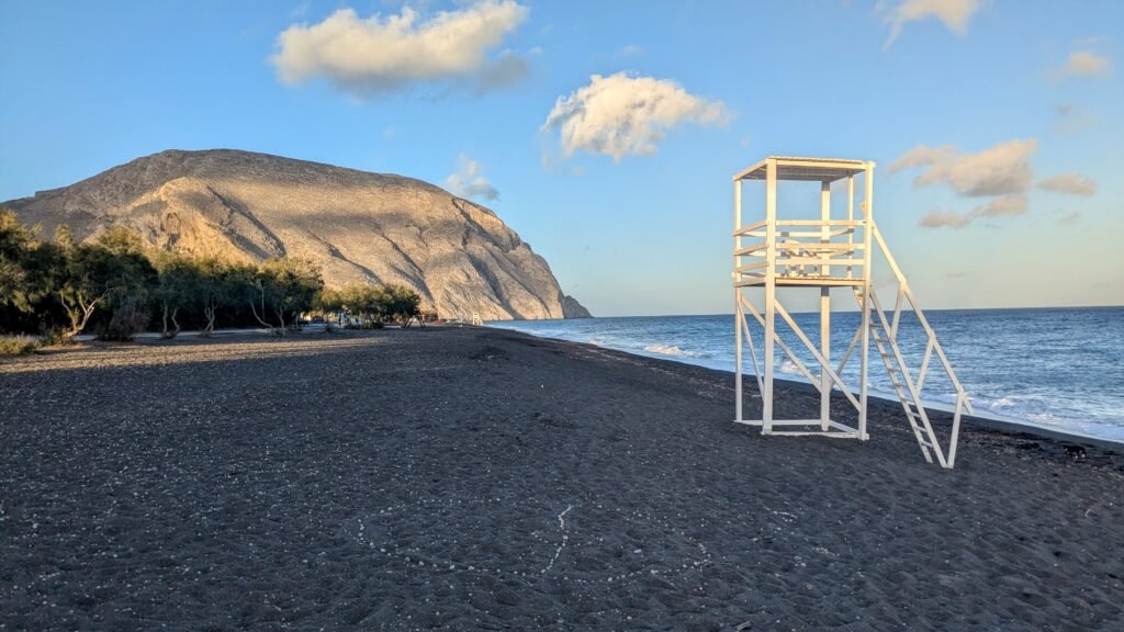 the black volcanic sand of perissa beach on santorini