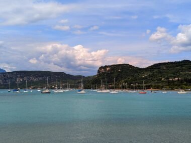 the blue water of lake garda with mountains in the background