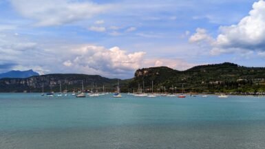 the blue water of lake garda with mountains in the background